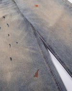 Spray-painted distressed jeans