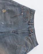 Distressed ripped denim trousers