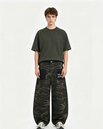 Distressed patchwork camouflage trousers