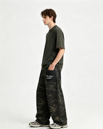 Distressed patchwork camouflage trousers